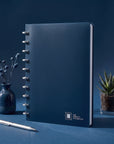 The Perfect Notebook — navy disc-bound notebook on a desk