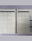 Printed sample of the 2027/2028 monthly calendar refill – open spread, side view