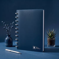 The Perfect Notebook — navy disc-bound notebook on a desk